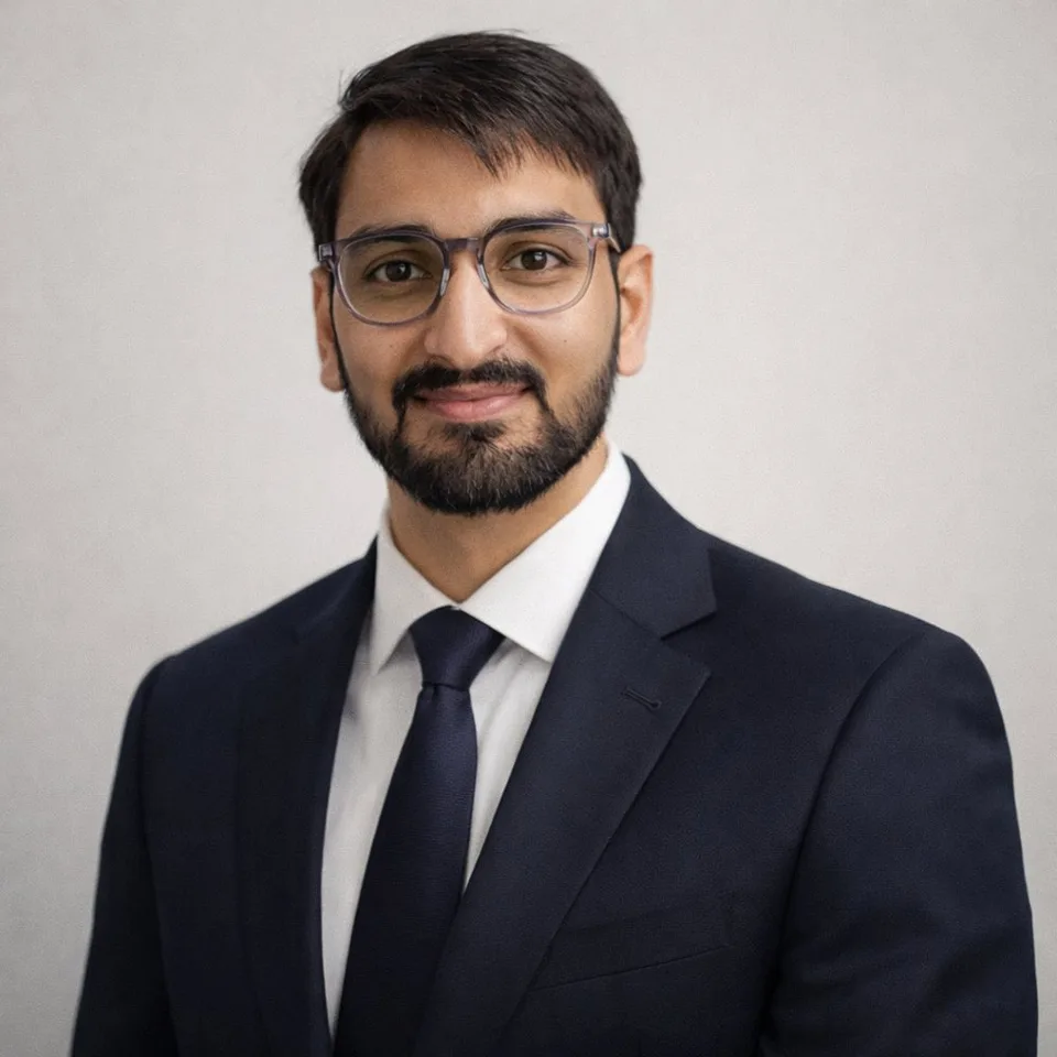 Ashutosh Shrivastava, founder of WOOKhoop, in a navy suit and glasses.